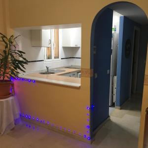 a kitchen with an archway and a counter with lights at BED & BREAKFAST Benalmádena HABITACION EN PISO COMPARTIDO in Benalmádena