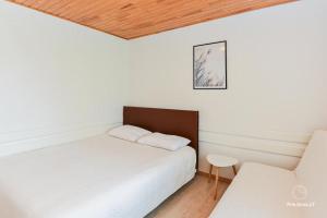 a bedroom with two beds and a table and a chair at RAMYBĖS OAZĖ 2 in Šventoji