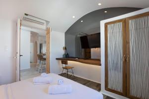 a hotel room with a bed and a kitchen and a room at KaLanAn Luxury Apartment in Aggelika +24 photos