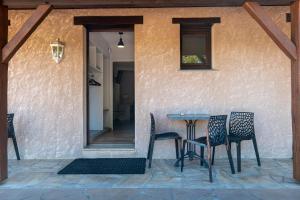 a table and chairs sitting on a patio at Hotel Village Motel in Tournus