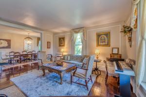 a living room with a couch and a table at Monroe Manor Inn in South Haven