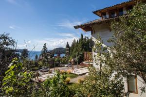 a building with a view of the ocean in the background at Bustillo 7500 in San Carlos de Bariloche