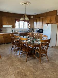 a kitchen with a table and chairs and a refrigerator at Farmhouse at Landyshade in Lancaster