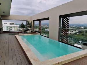a swimming pool in a house with a view at Paradise Room Rialto Residences in Santiago de los Caballeros