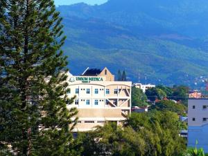a building with a mountain in the background at Paradise Room Rialto Residences in Santiago de los Caballeros