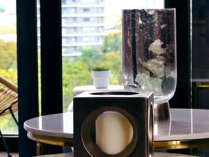 a bathroom with a toilet in front of a window at Paradise Room Rialto Residences in Santiago de los Caballeros