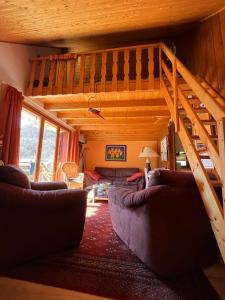 a living room with couches and a loft at Chalet Vue Montagne 6 personnes proche Sanctuaire de La Salette in La Salette-Fallavaux +24 photos