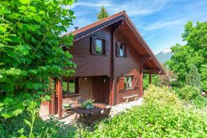 a log cabin with a table in front of it at Chalet l'Herminette in Saint-Jorioz