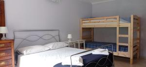 a bedroom with two bunk beds and a desk at AGRITURISMO Cré Seren in Susa