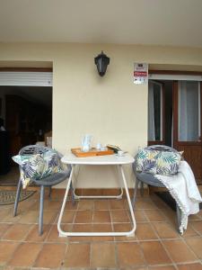 サンタンデールにあるSARDINERO CHALETのパティオ(白いテーブル、椅子2脚付)