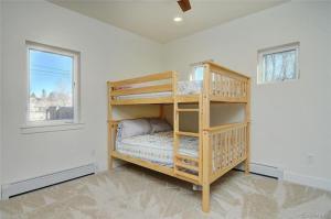 a bedroom with bunk beds in a room with a window at Cheerful, Spacious 3 Bdrm3 Bath, in Salida