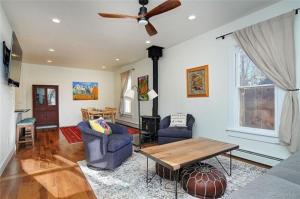 a living room with a ceiling fan and a table and chairs at Cheerful, Spacious 3 Bdrm3 Bath, in Salida