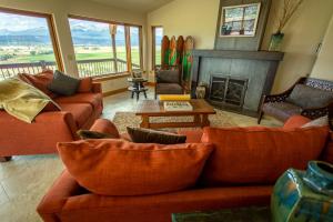 a living room with orange couches and a fireplace at Vista Grande 1 Mi To Salida 3 Or 4 Bdrm Options in Salida