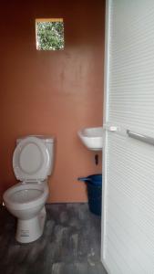 a bathroom with a toilet and a sink at Villa Lenda Resort - San Manuel, Pangasinan 