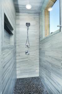 a bathroom with a shower with a shower head at She Shes Downtown Salidas Sunny Overlook in Salida