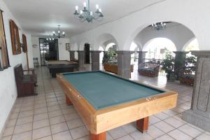 a pool table in the middle of a room at Hotel Arcada San Miguel de Allende in San Miguel de Allende