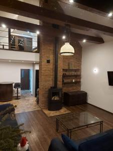 a living room with a fireplace and a couch at Szewnia Dolna in Szewnia