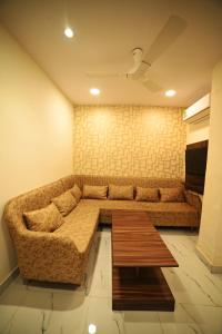 a living room with a couch and a coffee table at OVEL HOTEL (SKY VIEW) in Ludhiana