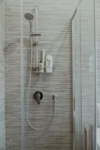 a shower with a shower head in a bathroom at La casa di Grazia in Rome