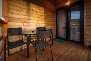 a room with chairs and a table in a cabin at Outdoor Resort Pecka in Mrkonjić Grad