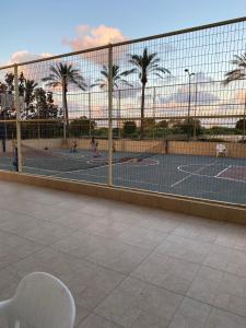 a tennis court with people playing tennis on the courts at Exclusive view ocean in Natanya the sea promenade in Netanya