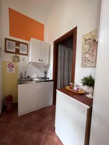 cocina con armarios blancos, fregadero y encimera en V57 APARTMENT OKTOGON, en Budapest