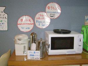 a microwave sitting on a table with signs on it at Mashu Onsen Hotel Mashu - Vacation STAY 69295v in Teshikaga