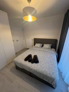 a bedroom with a bed with a pair of shoes on it at Apartment Brussels Airport and NATO OTAN headquarters in Machelen