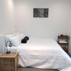 a bedroom with two beds and a night stand at Cosy flat - with excellent transport links in South Norwood