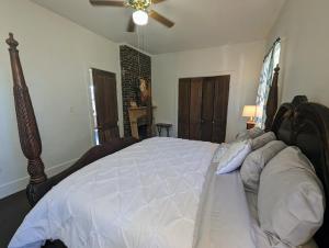 a bedroom with a large bed with a ceiling fan at Villas de Frenchmen in New Orleans