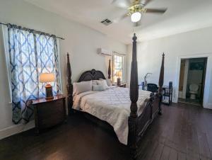 a bedroom with a bed and a ceiling fan at Villas de Frenchmen in New Orleans