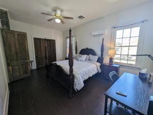 a bedroom with a bed and a ceiling fan at Villas de Frenchmen in New Orleans
