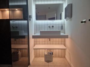 a bathroom with a sink and a mirror at Beautiful Rooms in London in London