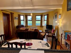 a living room with a couch and a table at Bloomfield Steading in Laurencekirk
