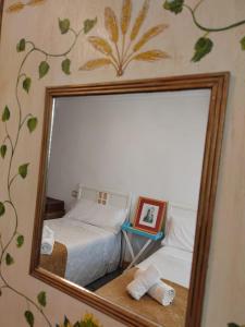 a mirror reflection of a bed in a bedroom at Apartamento ALBACETE CENTRO con 1 plaza de PARKING GRATIS in Albacete