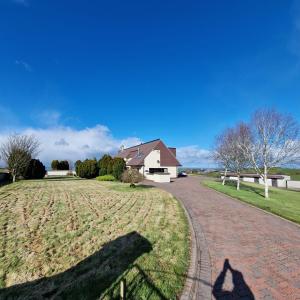 a shadow of a person walking down a driveway at Hill Top House 