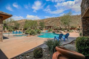 a swimming pool in a yard with blue chairs at B11-Red Cliff Suite-Second Floor 3-bedroom Sunset view in Washington
