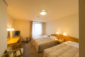 Voodi või voodid majutusasutuse Sky Hotel Uozu Annex toas