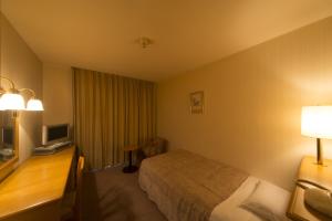 Voodi või voodid majutusasutuse Sky Hotel Uozu Annex toas