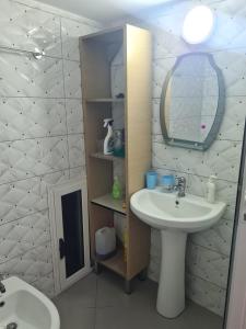 a bathroom with a sink and a mirror at Guest House Ilir in Berat