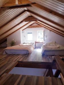 two beds in a attic room with wooden ceilings at Sunny Bay House in Kotor