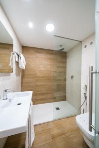 a bathroom with a shower and a white sink at La Colina in Geria