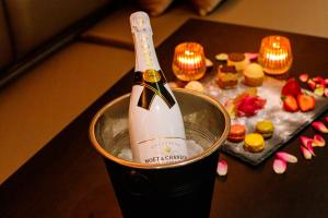 a bottle of champagne in a bucket on a table at Privé Spa L'amour in Nuenen