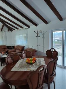 a living room with a wooden table and chairs at Guest House Ilir in Berat