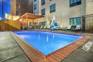 a large blue swimming pool in front of a building at TownePlace Suites Dallas Plano/Richardson in Plano