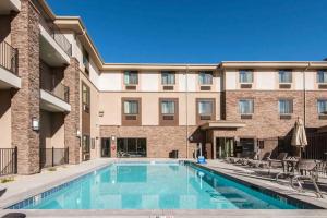 a swimming pool in front of a apartment building at Sleep Inn & Suites Moab near Arches National Park in Moab