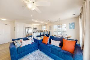 a living room with a blue couch and orange pillows at Surfside #6 in Mexico Beach