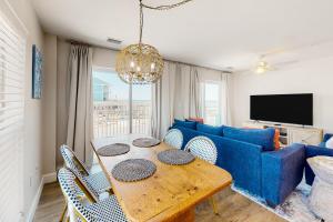 a living room with a table and a blue couch at Surfside #6 in Mexico Beach