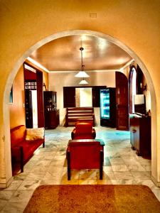 a living room with a couch and a chair in a room at Dom Alberto Hostel in Corumbá