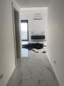 an empty white room with a marble floor at A. Montenegro in Dobra Voda